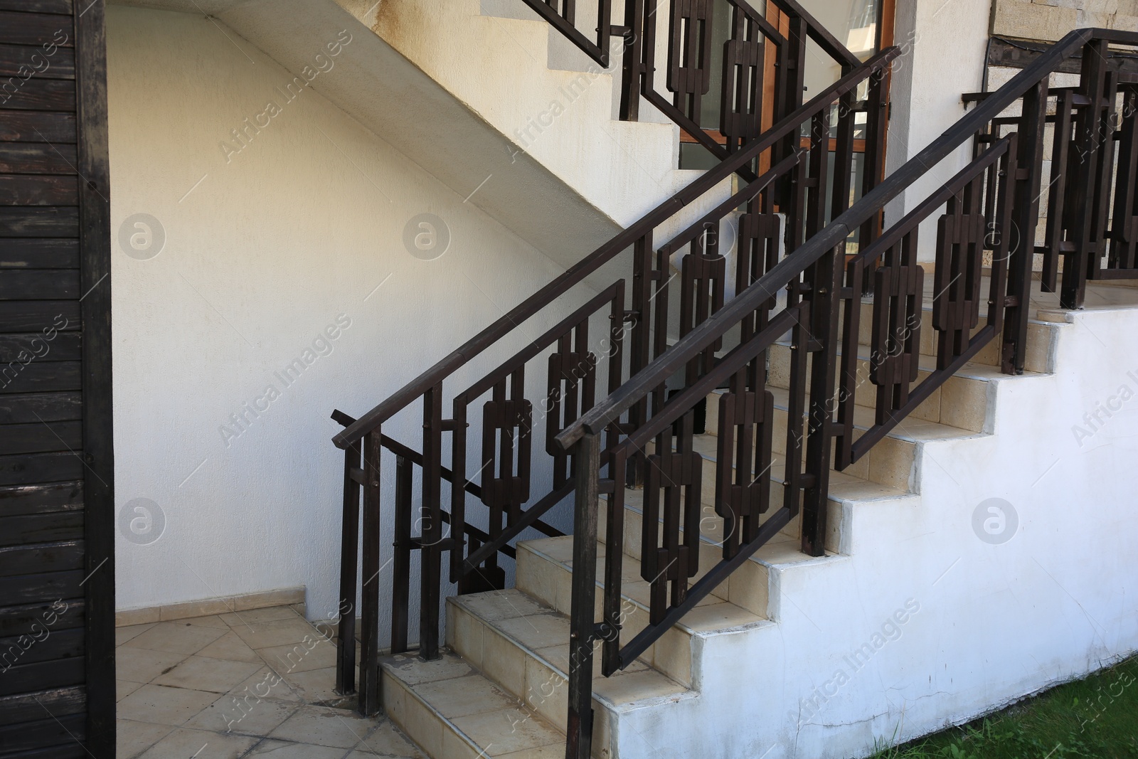 Photo of View of beautiful stairs with metal handrails near house outdoors