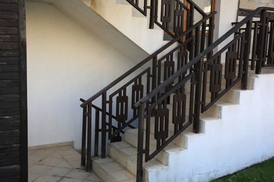 Photo of View of beautiful stairs with metal handrails near house outdoors