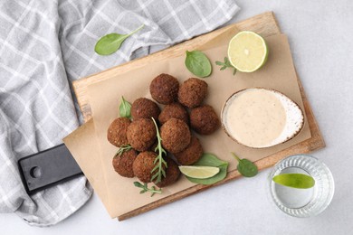 Photo of Delicious falafel balls served on light table, top view