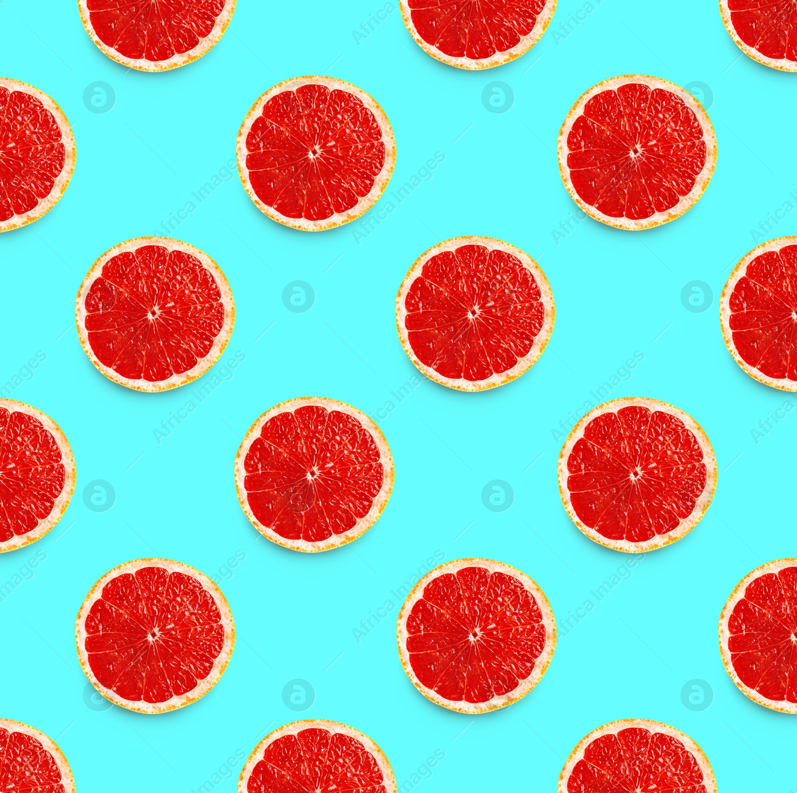 Image of Many fresh ripe slices of grapefruits on turquoise background, flat lay. Seamless pattern design