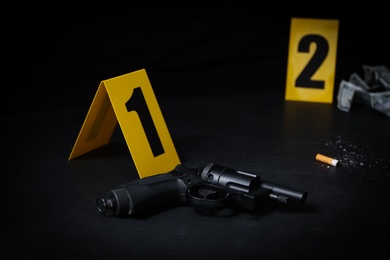 Photo of Crime scene markers and evidences on black background