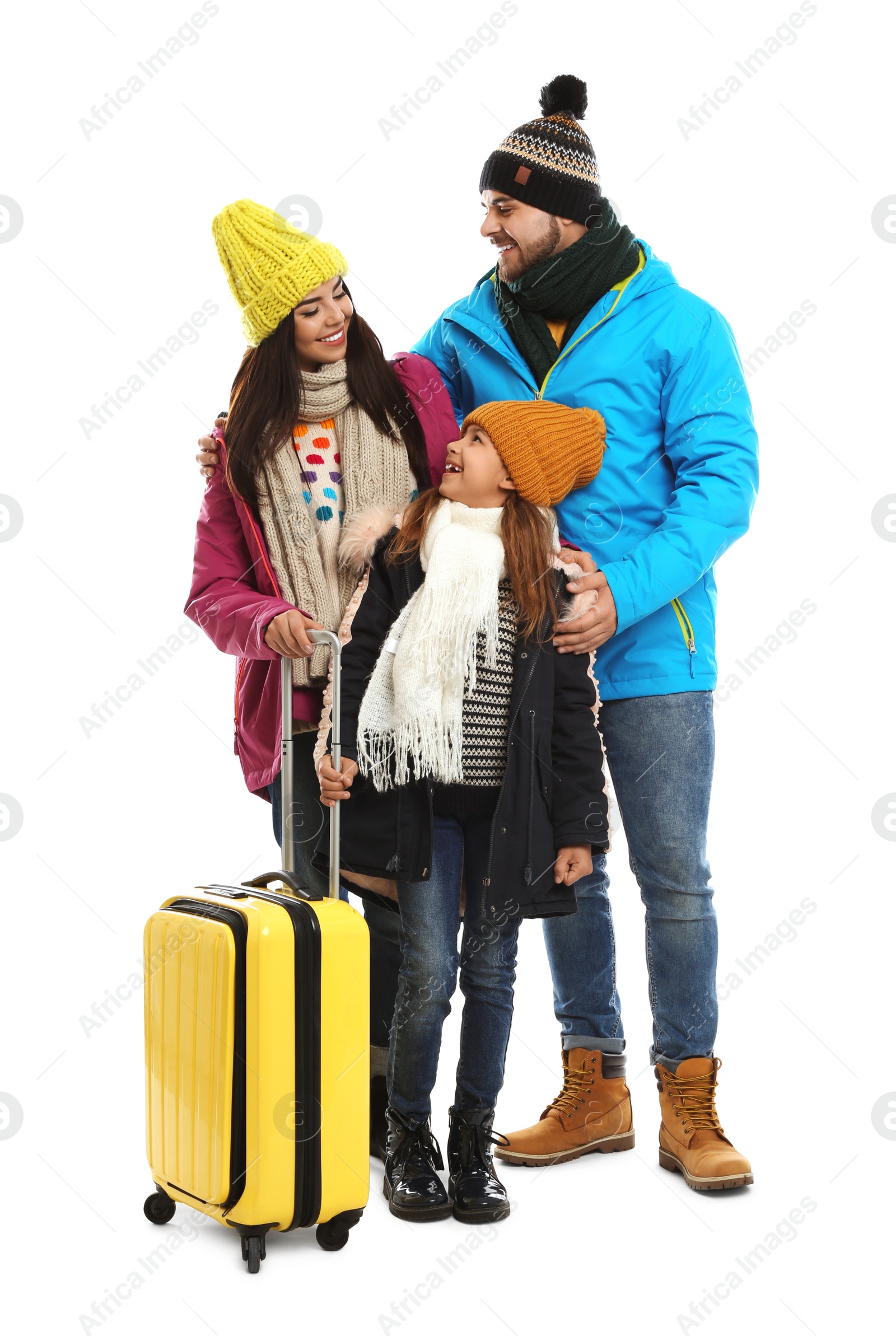 Photo of Happy family in warm clothes with suitcase on white background. Winter vacation