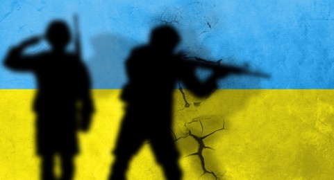 Silhouettes of soldiers with Ukrainian flag colors on background, space for text. Military service during war