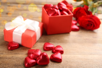 Photo of Heart shaped chocolate candies on wooden table