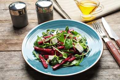 Photo of Plate with delicious beet salad served on table