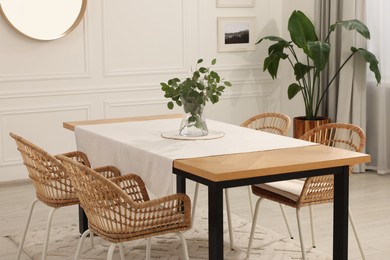 Stylish dining room with cozy furniture and plants