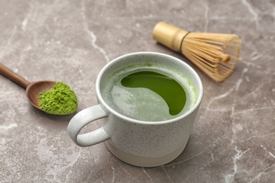 Cup of fresh matcha tea on table