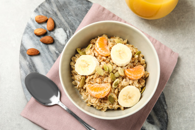 Photo of Tasty healthy breakfast served on light grey table, flat lay