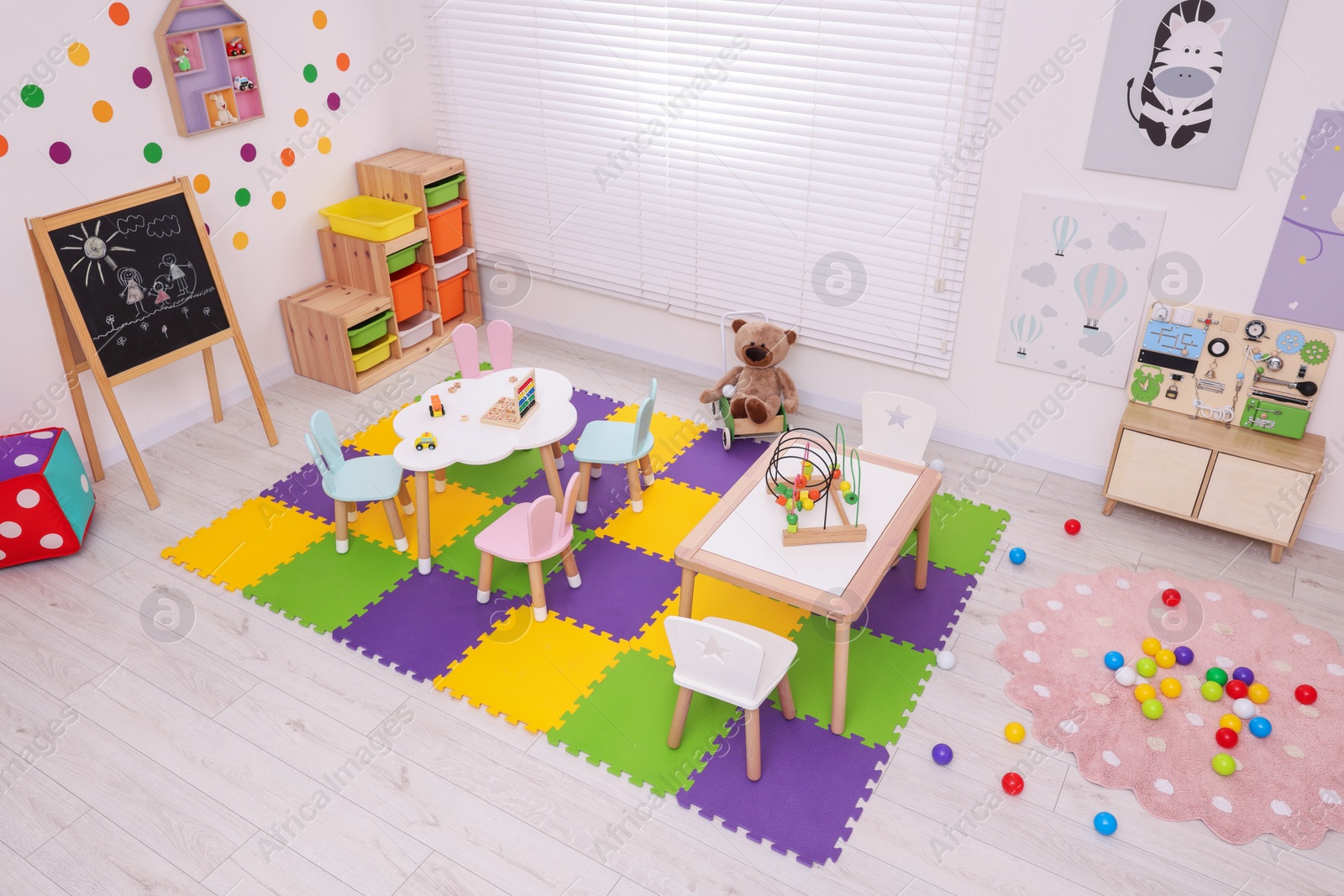 Photo of Stylish kindergarten interior with toys and modern furniture, above view