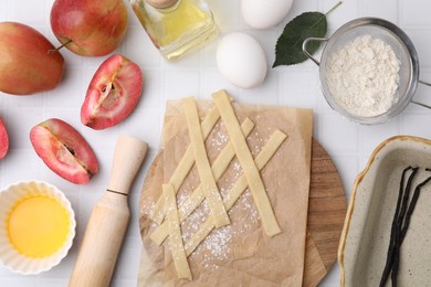 Photo of Making apple pie. Different ingredients and cookware on white tiled table, flat lay