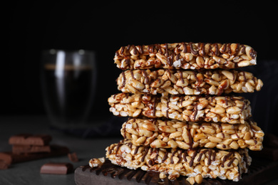 Photo of Delicious rice crispy treats on black background