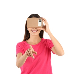 Young woman using cardboard virtual reality headset, isolated on white