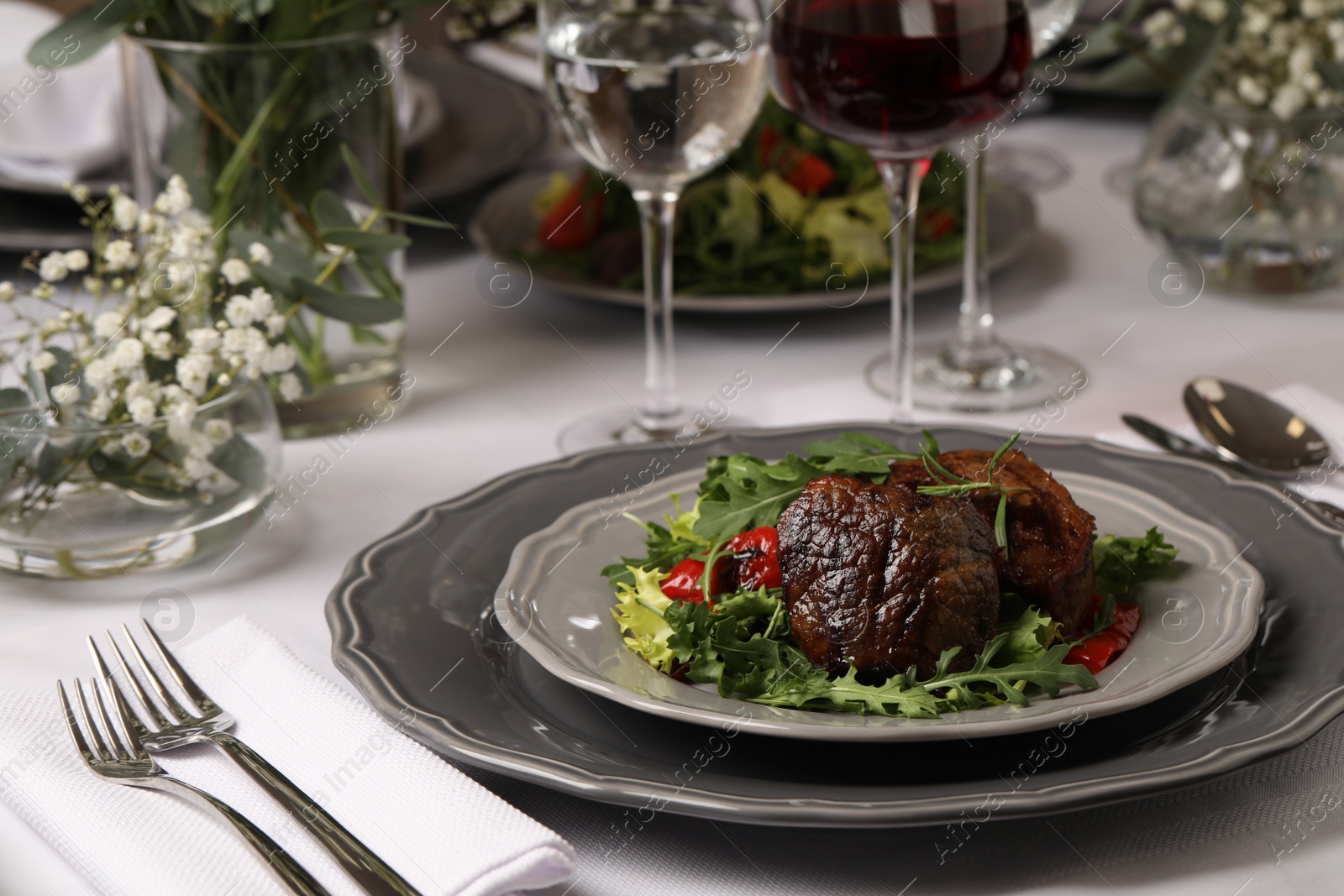 Photo of Delicious grilled meat with vegetables served on table in restaurant