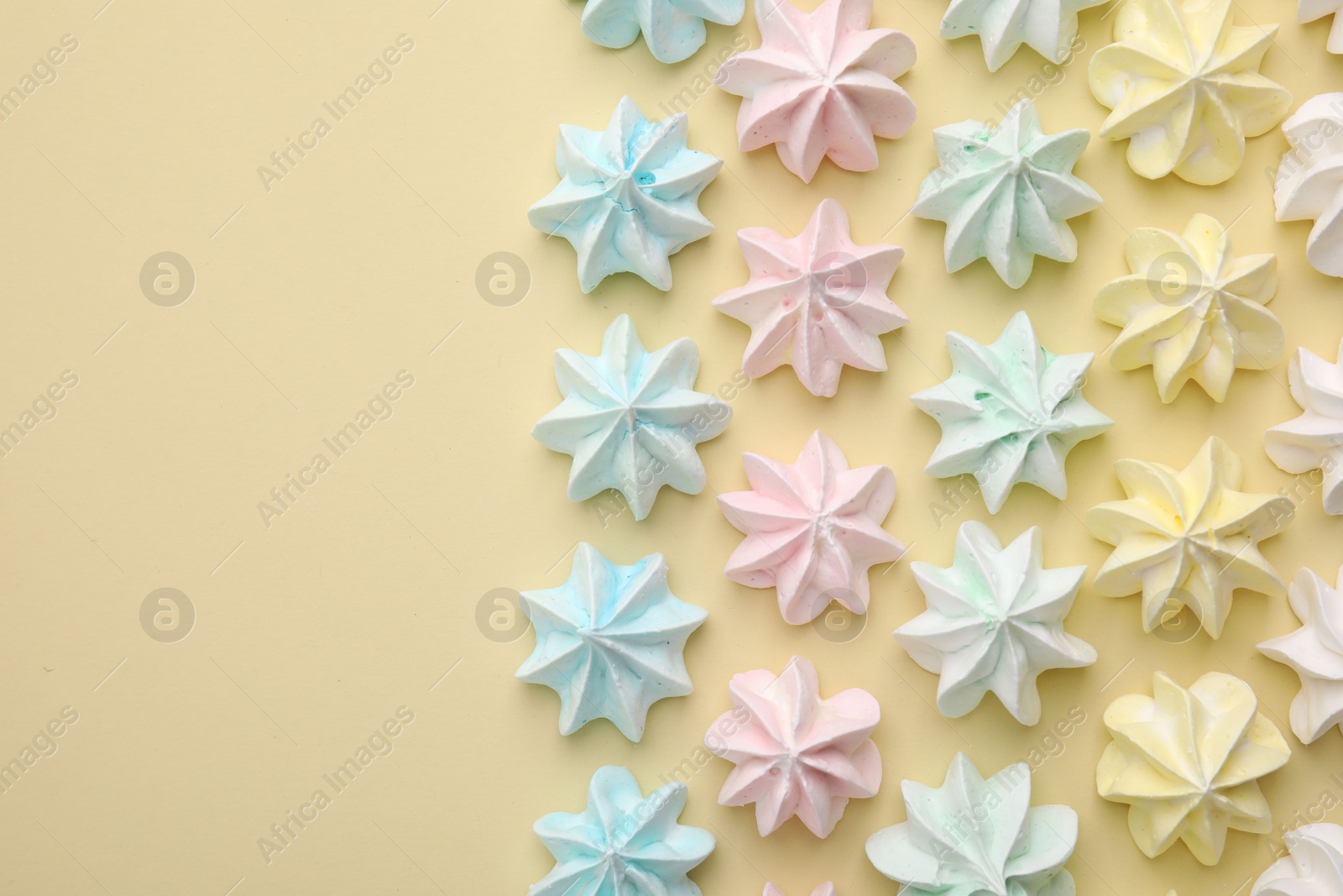 Photo of Delicious meringue cookies on beige background, flat lay. Space for text