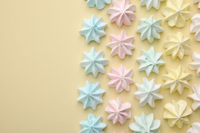 Delicious meringue cookies on beige background, flat lay. Space for text