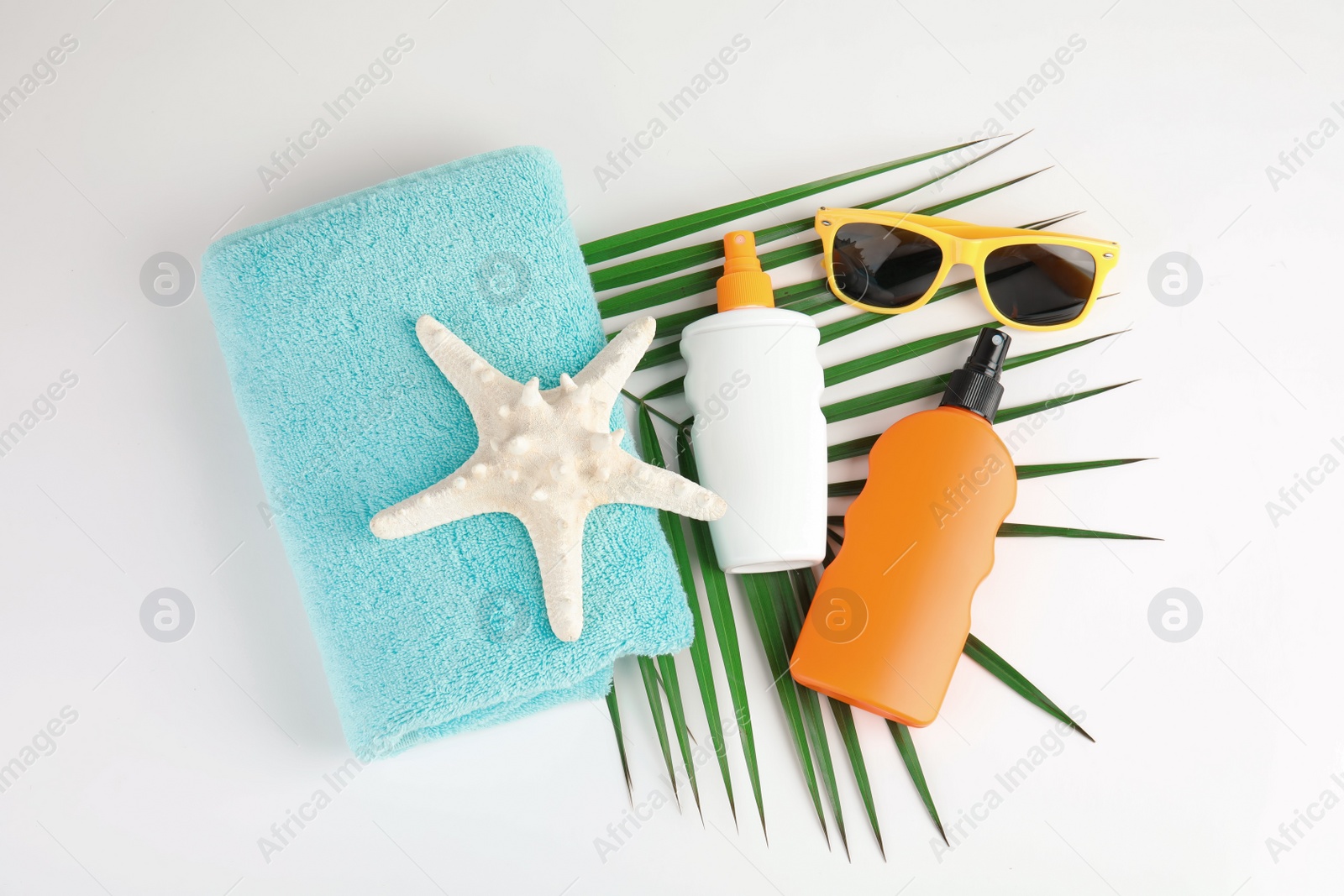 Photo of Composition with sun protection products on white background, top view