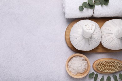 Photo of Flat lay composition with spa products and eucalyptus branches on grey table. Space for text