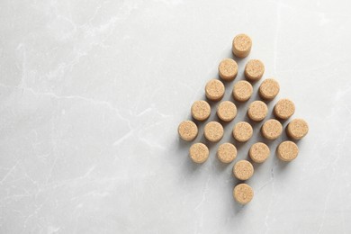 Photo of Christmas tree made of wine corks on beige table, top view. Space for text