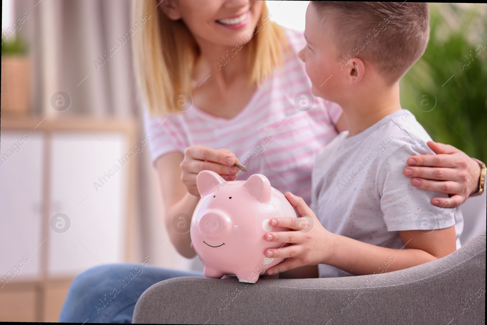 Photo of Family with piggy bank and money at home