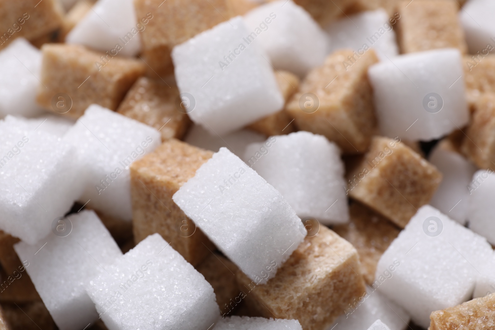 Photo of White and brown sugar cubes as background, closeup