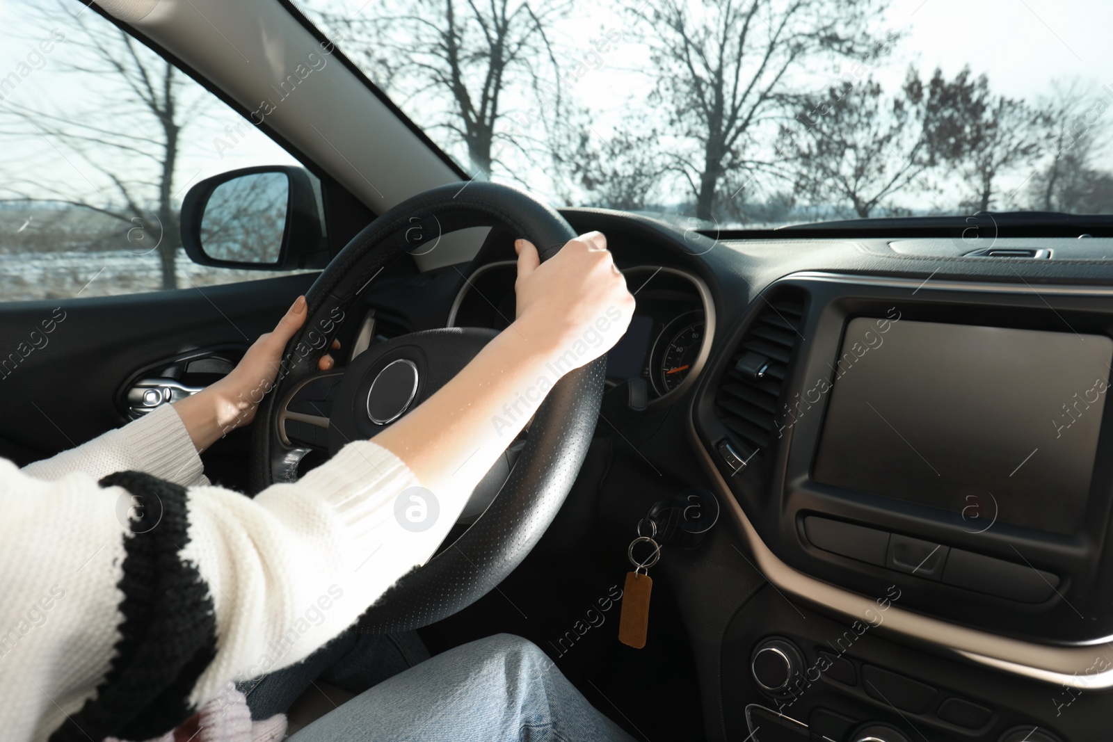 Photo of Young woman driving car, closeup view. Cozy atmosphere