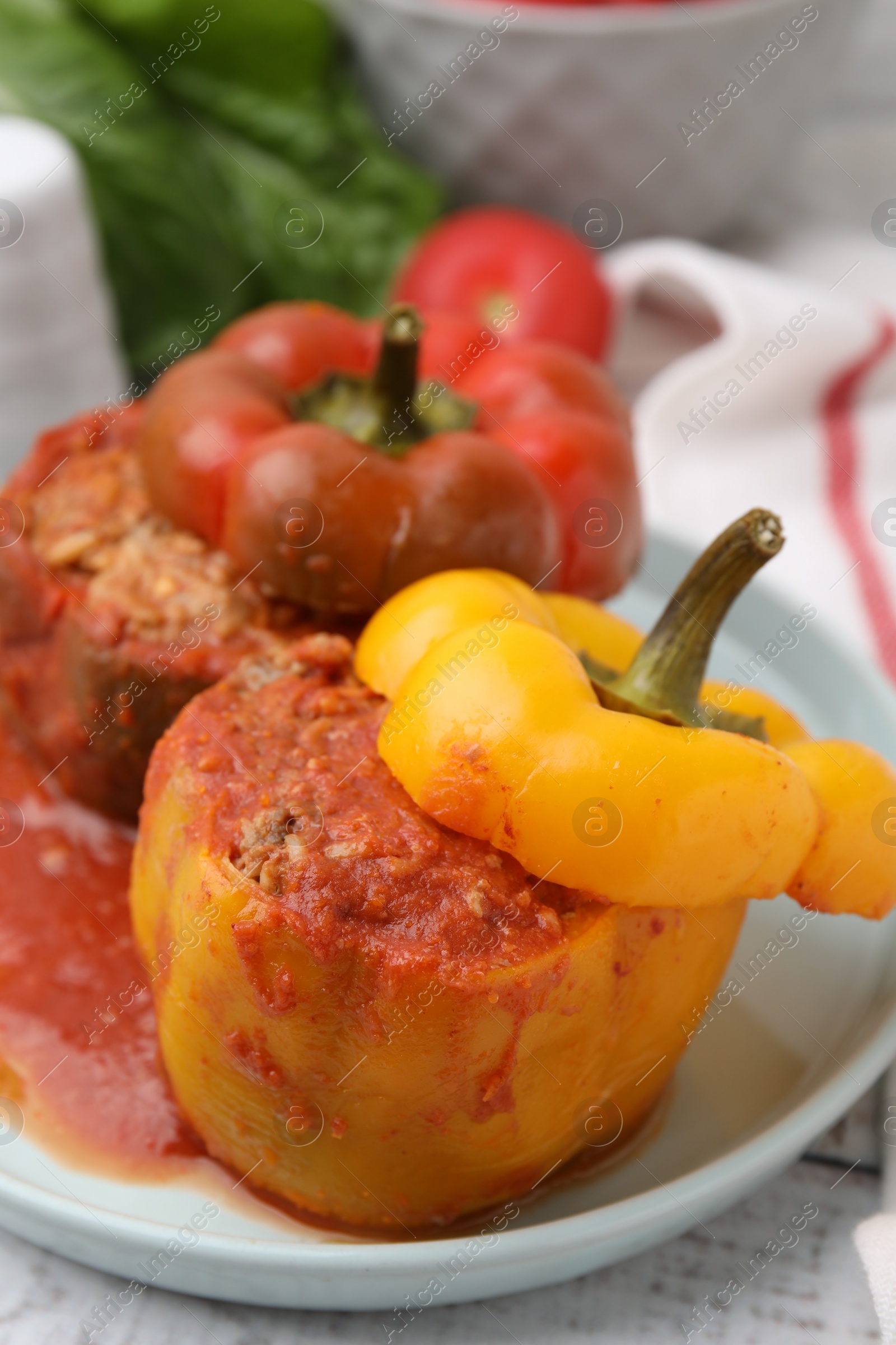 Photo of Delicious stuffed bell peppers on white wooden table