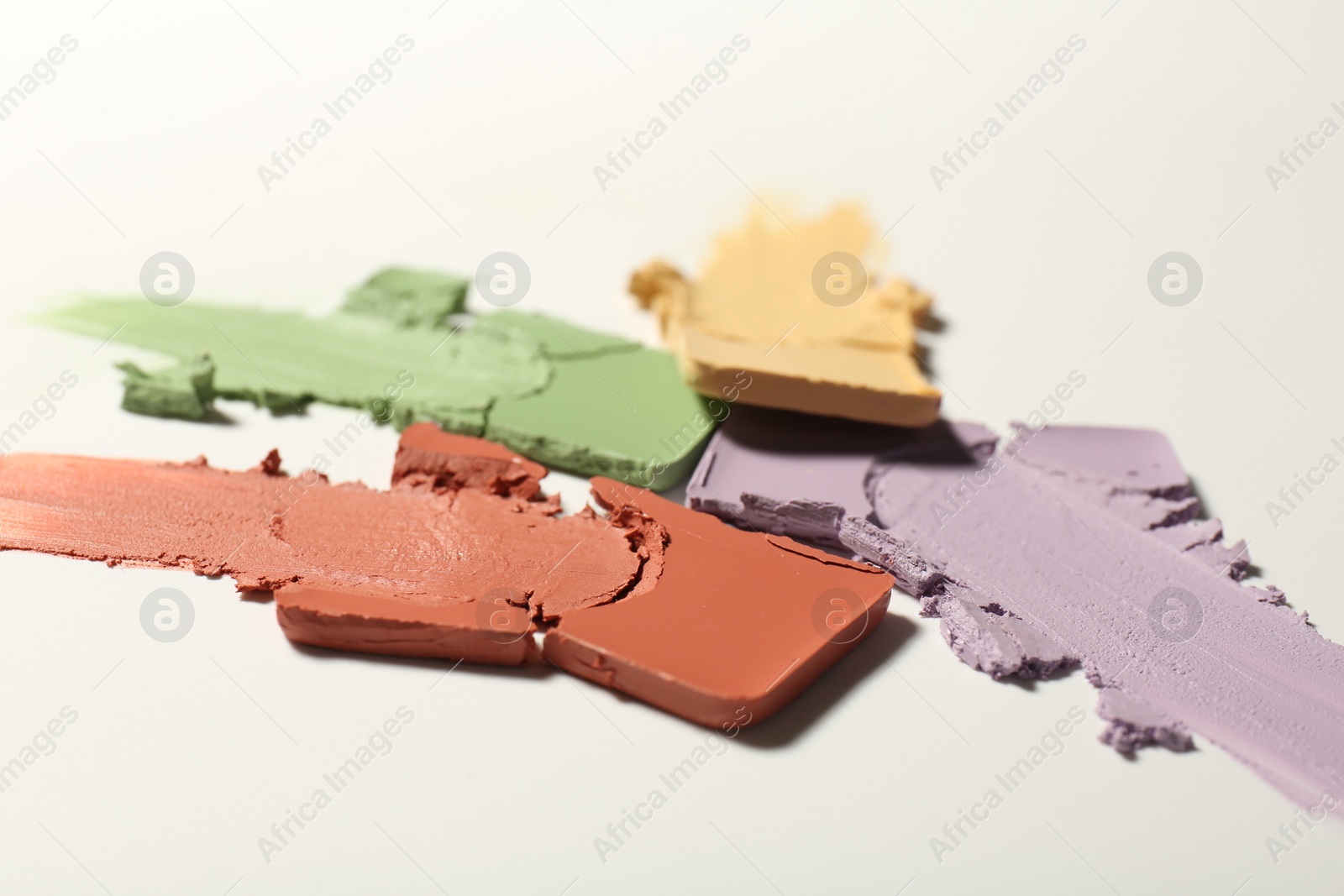 Photo of Samples of different color correcting concealers on white background