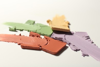 Photo of Samples of different color correcting concealers on white background