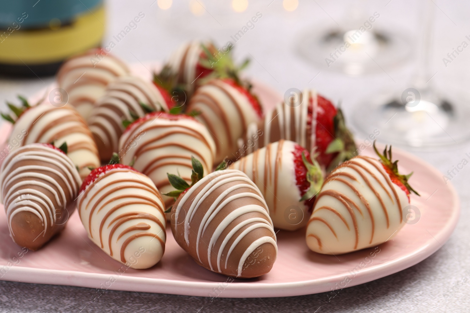 Photo of Delicious chocolate covered strawberries on light table, closeup