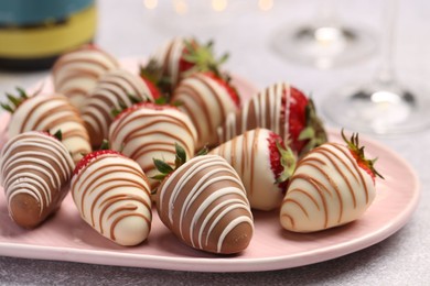 Photo of Delicious chocolate covered strawberries on light table, closeup