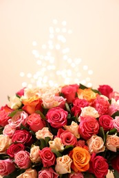 Beautiful bouquet of colorful roses on beige background