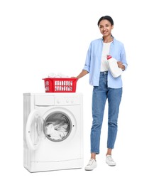 Beautiful woman with detergent and laundry basket near washing machine on white background