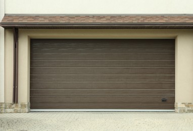 Photo of Building with wide brown sectional garage door