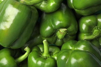 Ripe green bell peppers as background, top view