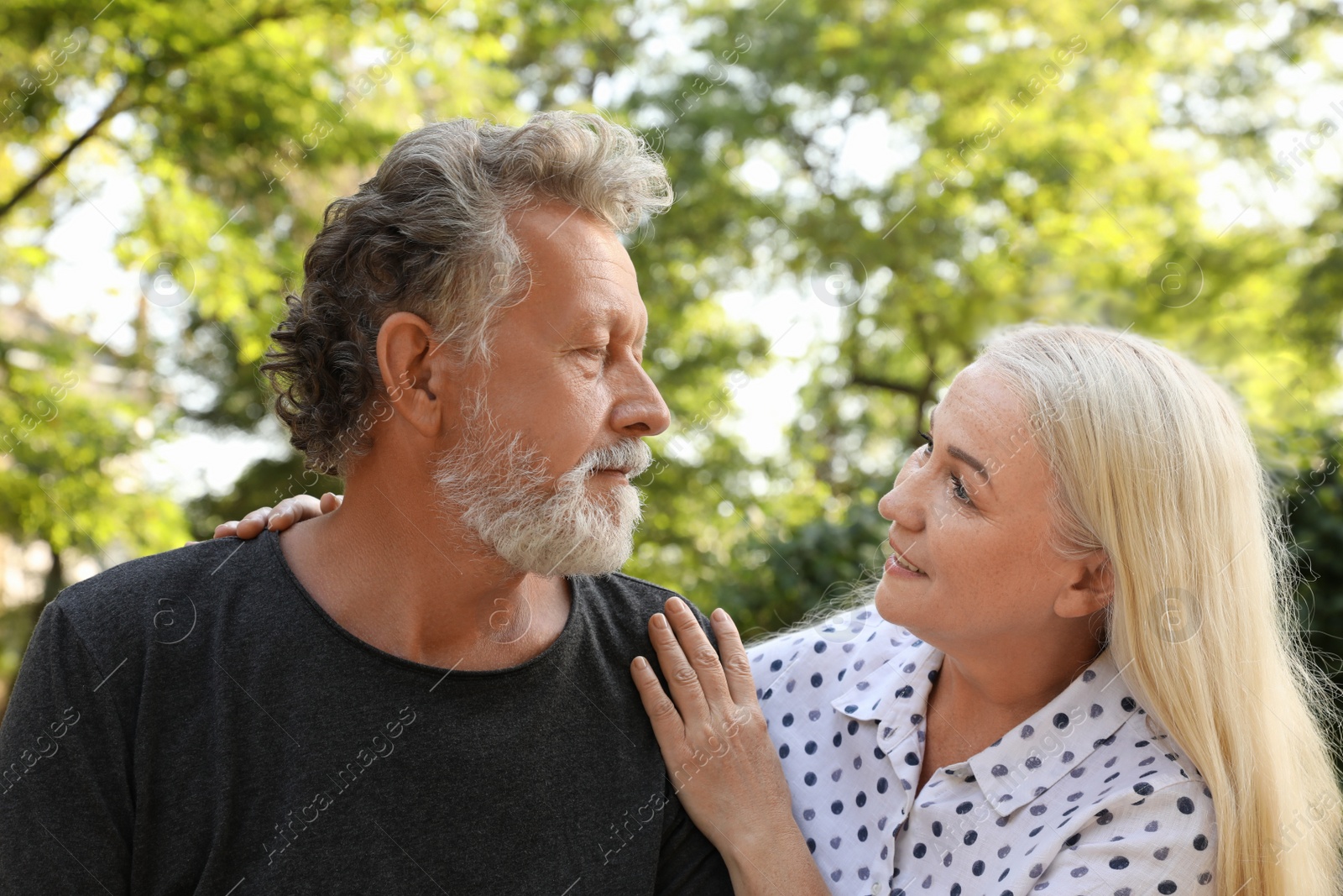 Photo of Lovely mature couple resting together in park