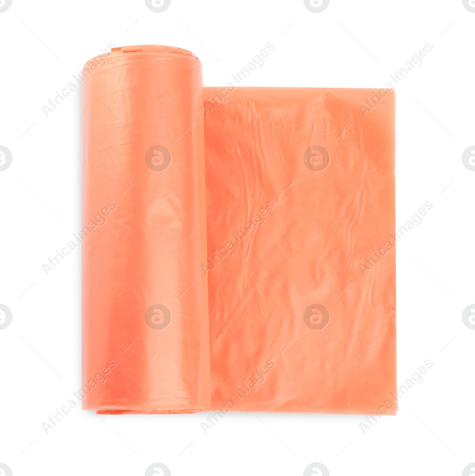 Photo of Roll of orange garbage bags isolated on white, top view