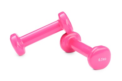 Photo of Pink dumbbells isolated on white. Sports equipment