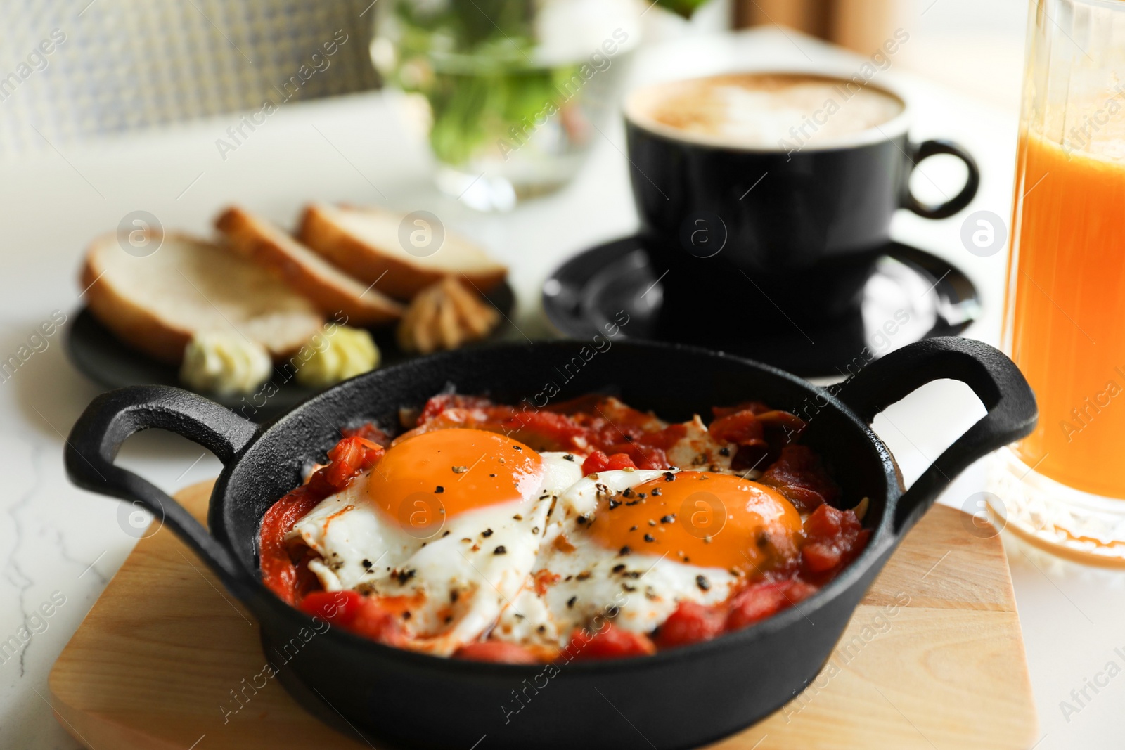 Photo of Tasty Shakshouka served on white table. Traditional Arabic dish