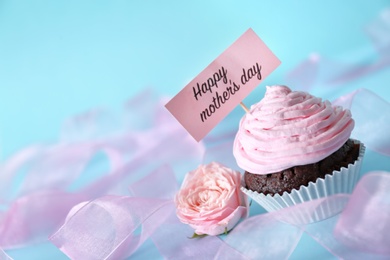 Photo of Festive surprise with tasty treat for Mother's Day on color background