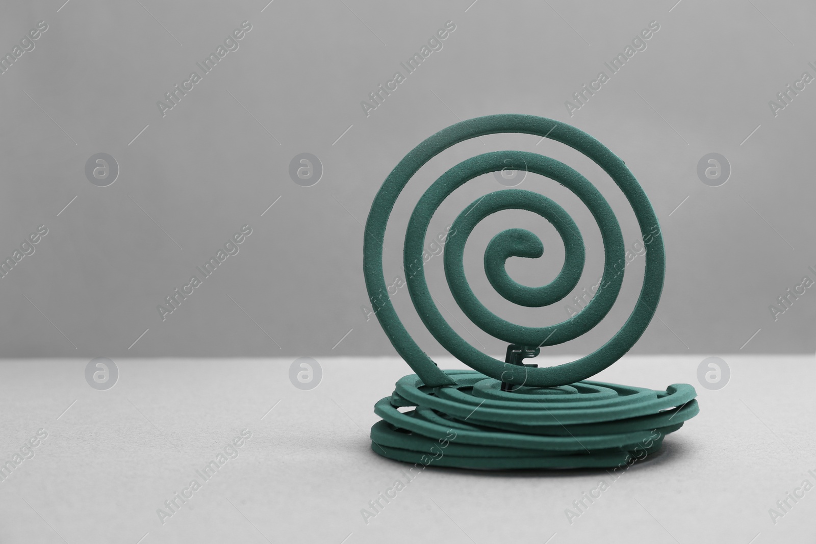 Photo of New insect repellent coils on grey background Space for text