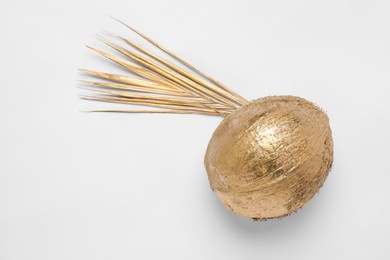 Photo of Shiny golden wheat spike and coconut on white background, top view. Decor elements