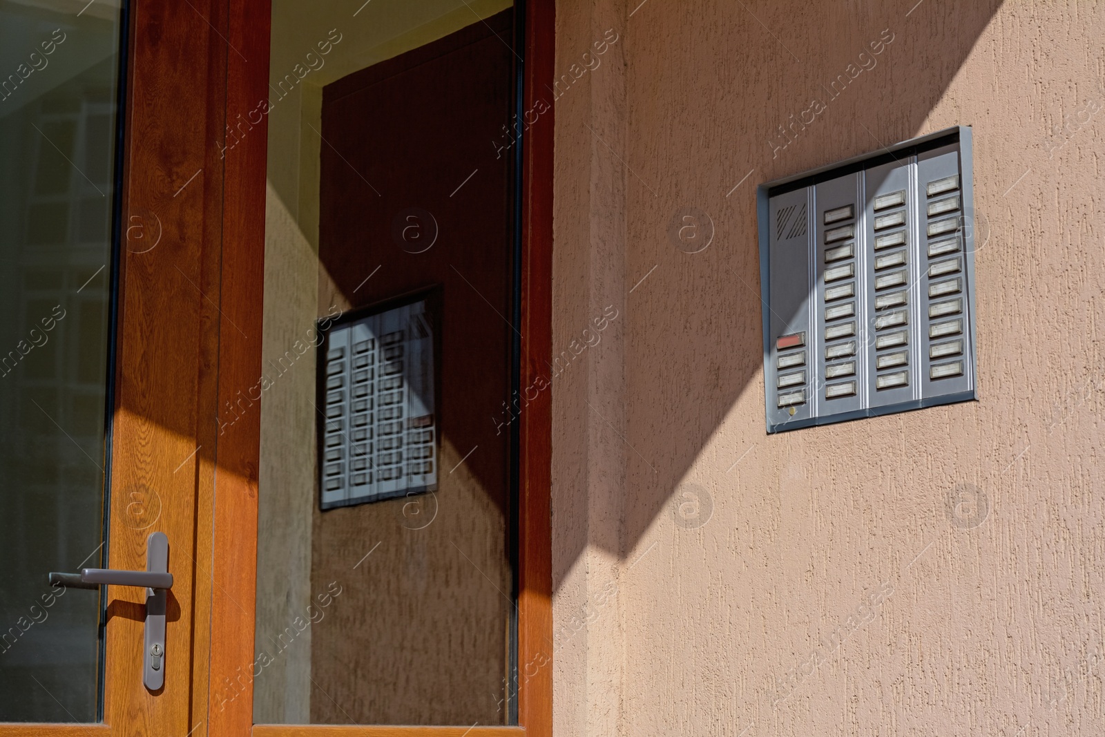 Photo of Wall with intercom outdoors on sunny day, space for text