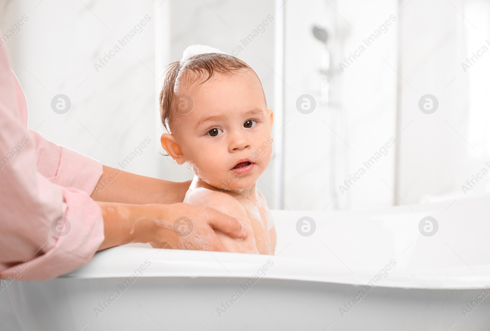 Photo of Mother with her little baby in bathroom