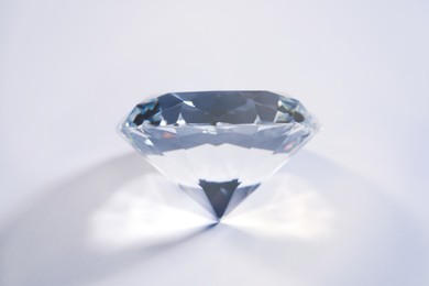 Photo of Beautiful dazzling diamond on white background, closeup