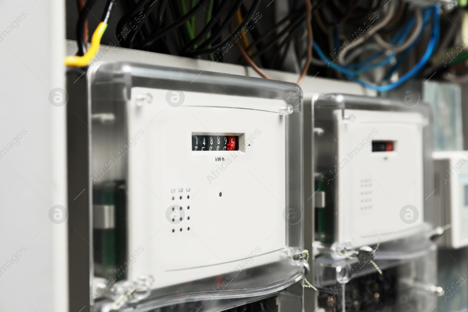 Photo of Electric meters and wires in fuse box, closeup