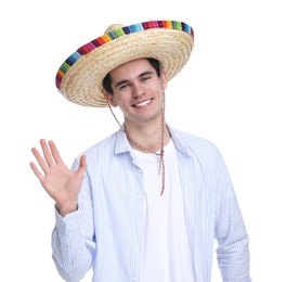 Young man in Mexican sombrero hat waving hello on white background