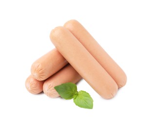 Delicious boiled sausages and basil on white background