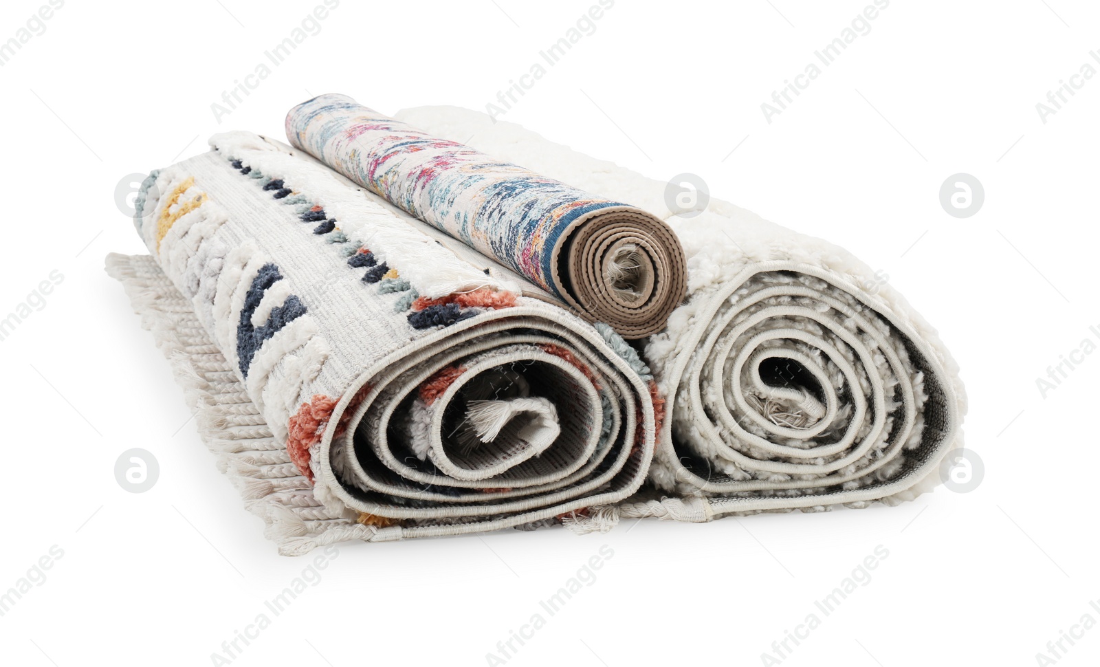 Photo of Rolled carpets on white background. Interior element