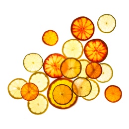 Illuminated slices of citrus fruits on white background, top view