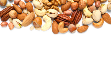 Different delicious nuts on white background, flat lay. Space for text